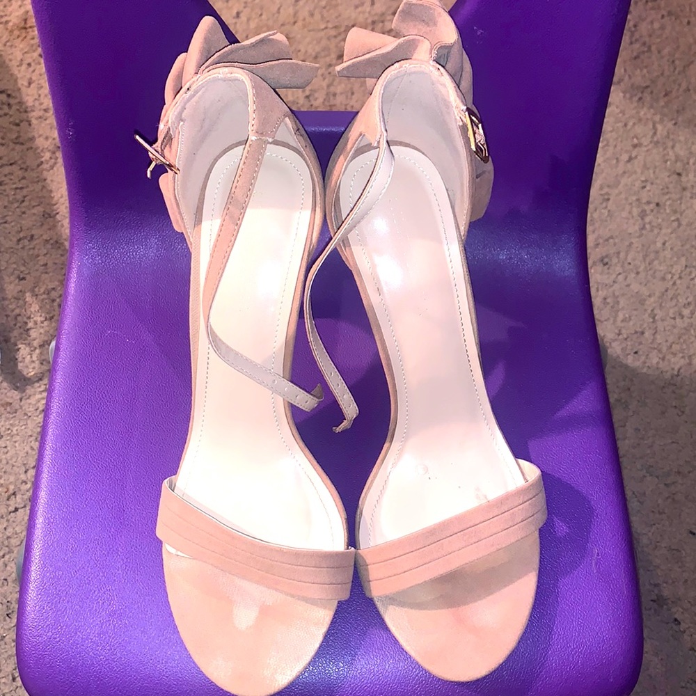 Open toe high heel sandals with ankle strap and fringe on the back of the heel